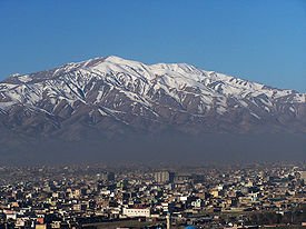 Kabul, overshadowed by a massive mountain, is functioning and making progress through engagement with the Taliban authority.